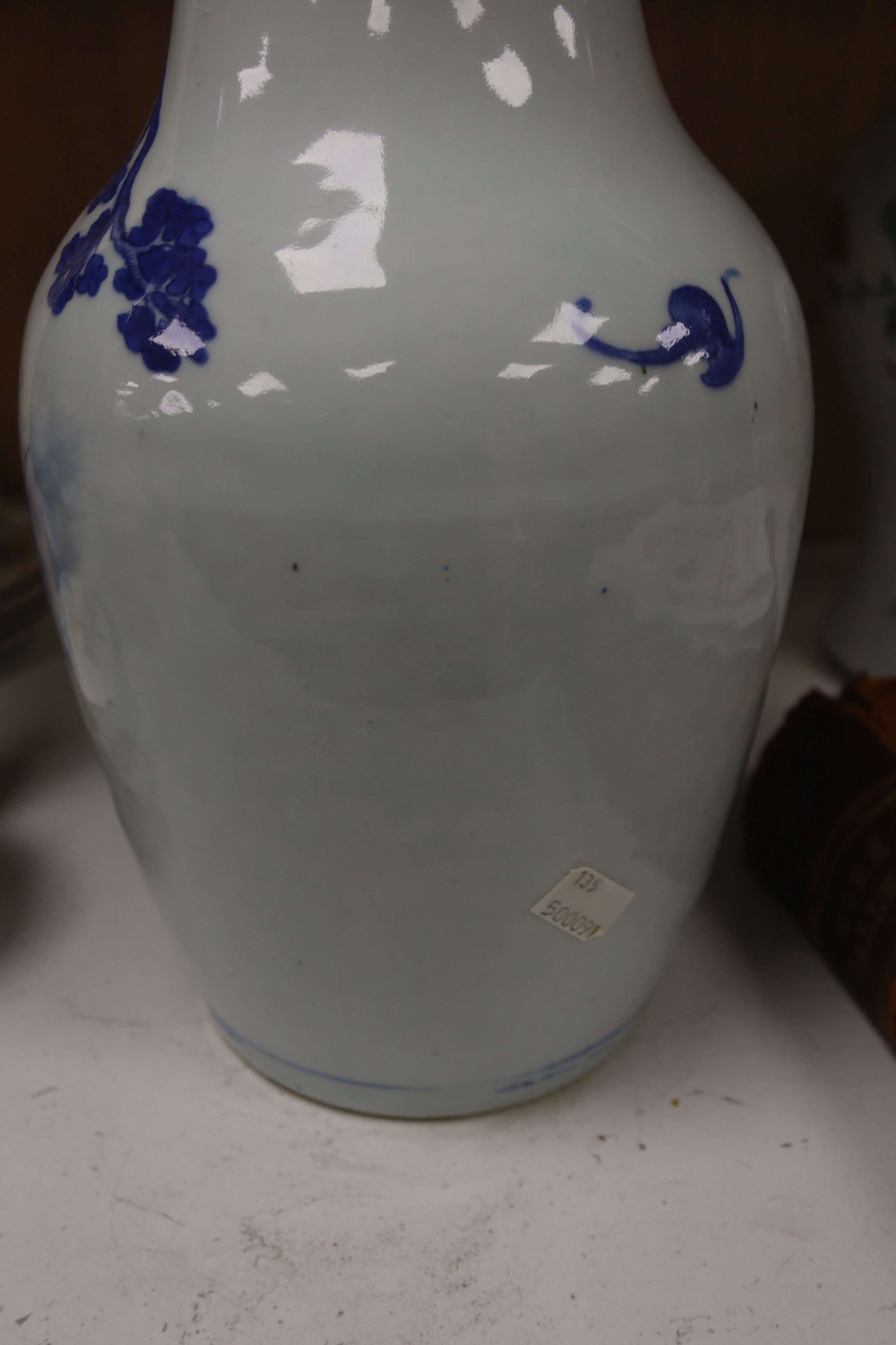 A Chinese blue and white 'Immortals' vase, 18th/19th century, damage, 34.5cm and a Chinese Yongzheng period famille rose ‘phoenix’ vase (reduced in height), 24cm